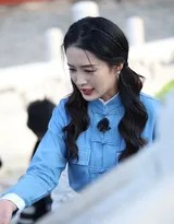 李沁侧身轻抚天坛红墙，双马尾发梢染上金色晨光