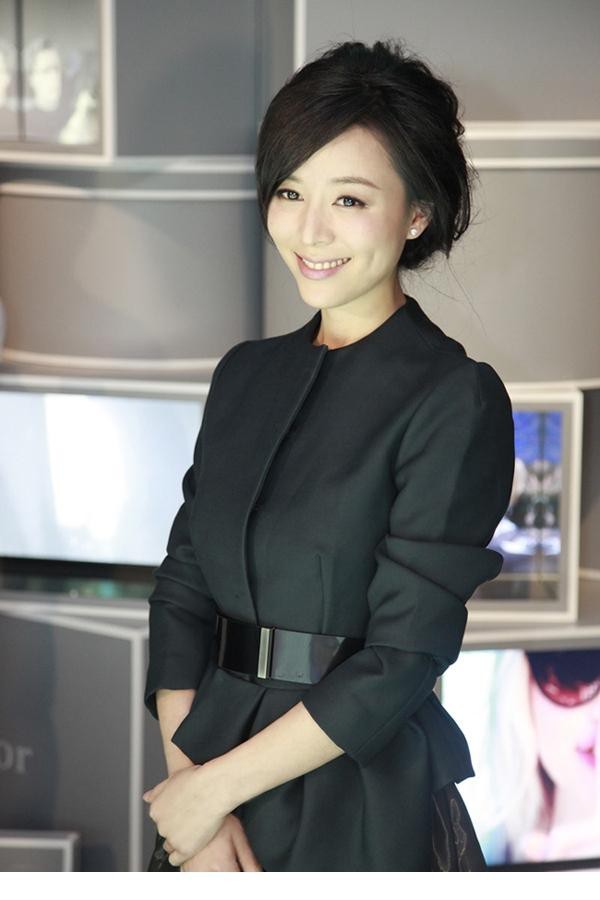 张静初端坐如画，蓬蓬裙铺展如云，静谧中散发高贵典雅气息